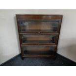 An early 20th century three tier oak stacking bookcase