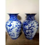 A pair of Chinese blue and white glazed ceramic vases depicting flowers, height 31.