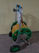 A Hozelock hose pipe on trolley