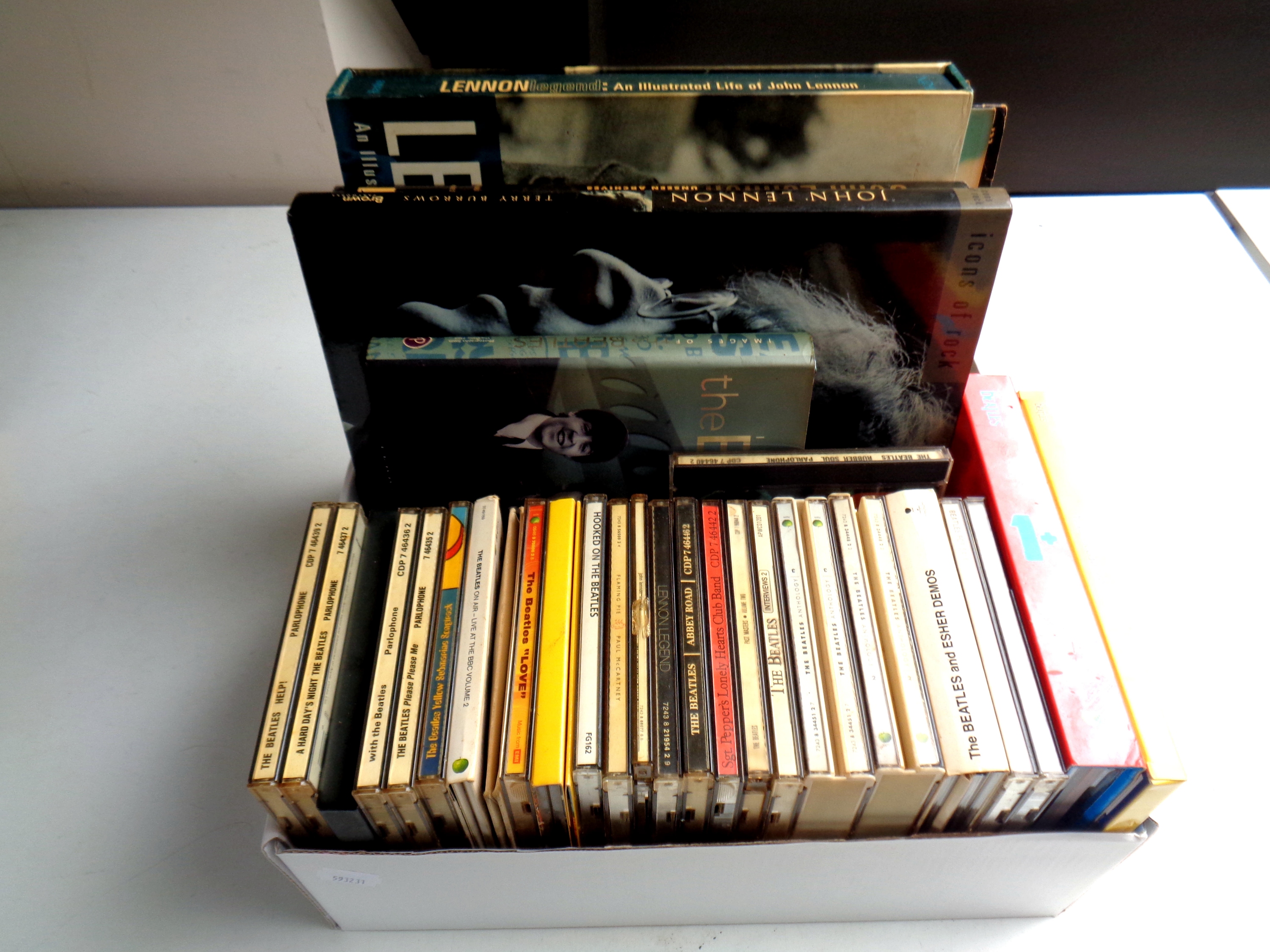 A box of a large quantity of CD's and books relating to The Beatles