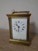 A brass cased carriage clock with key