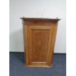 A 19th century oak hanging corner cabinet