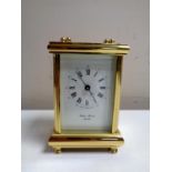 A brass cased Philip Morris eleven jewel carriage clock with key
