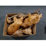 A box containing wooden animal ornaments to include giraffes, pigs,