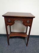 A 19th century mahogany inlaid two drawer side table on raised legs
