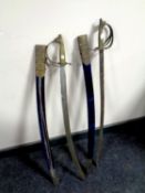 A pair of Indian brass handled swords in scabbards