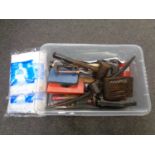 A box containing assorted hand tools, G clamps, pick axe head,