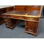 A Victorian style twin pedestal partner's desk with leather inset panels