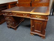 A Victorian style twin pedestal partner's desk with leather inset panels