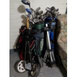 Three golf bags of assorted irons and drivers to include Dunlop, Ben Sayers, Big Bursar,