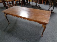 A mahogany rectangular coffee table on pad feet