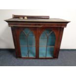 A 19th century mahogany double door bookcase top with pillar supports