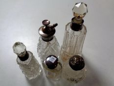 Five cut glass silver-topped and rimmed scent bottles