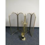 A brass four way folding spark guard together with a brass four piece companion set on stand
