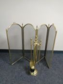 A brass four way folding spark guard together with a brass four piece companion set on stand