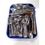 A tray containing a quantity of stainless steel cutlery