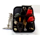A tray containing assorted metal wares to include plated candlestick,