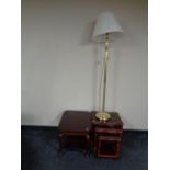 A two tier occasional table together with a nest of three glass topped tables in a mahogany finish,