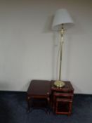 A two tier occasional table together with a nest of three glass topped tables in a mahogany finish,