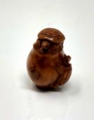 A carved hardwood netsuke - Turtle family in a pot