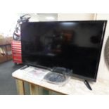 A JVC 32" LED TV with remote and instructions