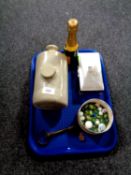 A tray of stoneware hot water bottle, plated cigarette case, marbles, silver badge,