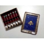 A silver photo frame together with a set of six cased silver teaspoons