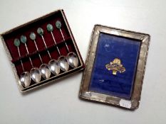 A silver photo frame together with a set of six cased silver teaspoons