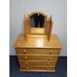 A Julian Bowen four drawer pine chest with triple mirror