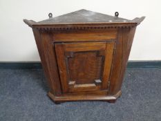 A 19th century hanging oak corner cupboard