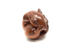 A carved hardwood netsuke - Rat scratching its nose