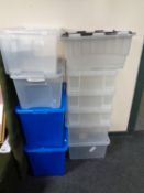 A quantity of plastic storage boxes with lids