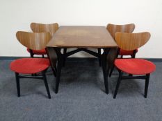 A 20th century teak G Plan drop leaf kitchen table together with four chairs