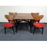 A 20th century teak G Plan drop leaf kitchen table together with four chairs