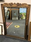 An ornate bevelled mirror,