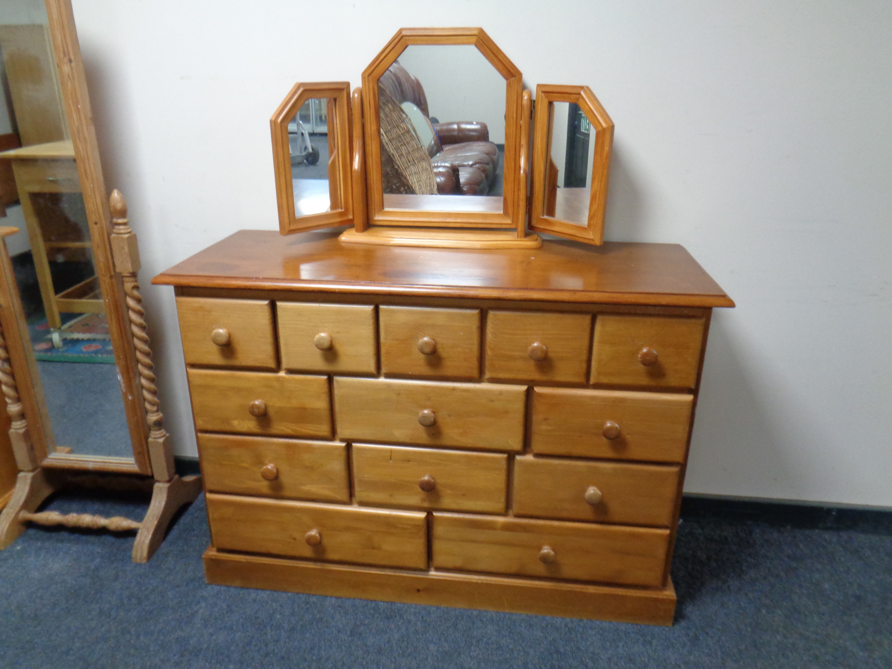 A pine multi drawer chest with triple mirror