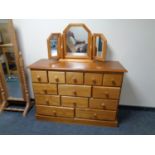 A pine multi drawer chest with triple mirror