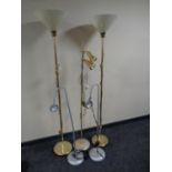 A pair of brass floor lamps with plastic shades together with three further floor lamps