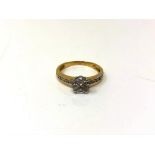 A pie-cut diamond ring on yellow gold shank set with diamond shoulders, size L.