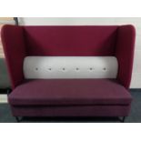 A contemporary high backed booth settee upholstered in a two-tone purple and grey fabric