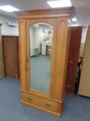 A pine single mirror door wardrobe