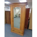 A pine single mirror door wardrobe