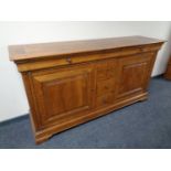 A good quality oak double door eight drawer buffet sideboard retailed by House of Fraser
