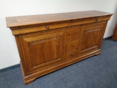 A good quality oak double door eight drawer buffet sideboard retailed by House of Fraser