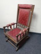 An American style rocking chair upholstered in a red fabric