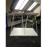 A pair of orange box bar stools on metal legs together with a coffee table on metal legs