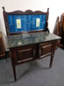 An Edwardian marble topped tiled back wash stand