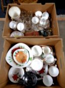 Two boxes containing part china tea services, commemorative goblets, vintage camera,