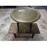 An eastern brass topped table together with a further coffee table with inset Victorian and