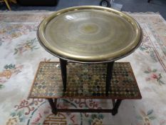 An eastern brass topped table together with a further coffee table with inset Victorian and